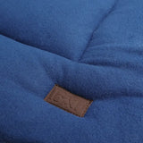 Blue quilted wool blanket with brown leather patch on benji and flo luxury fleece dog bed for cozy comfort