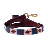A maroon sublime polo leather dog lead by benji & flo with a blue pink geometric patterned section and brass clip