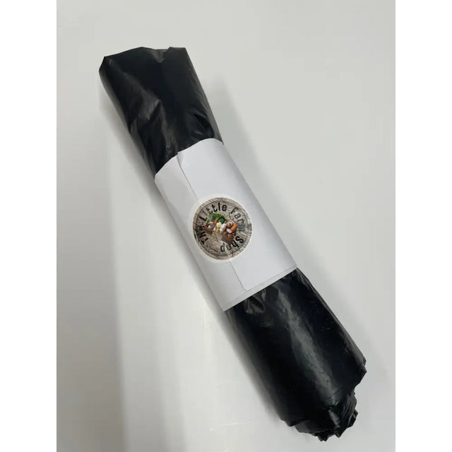 A black plastic wrapped pack of equestrian bin bags with a white paper band and little dudes sticker