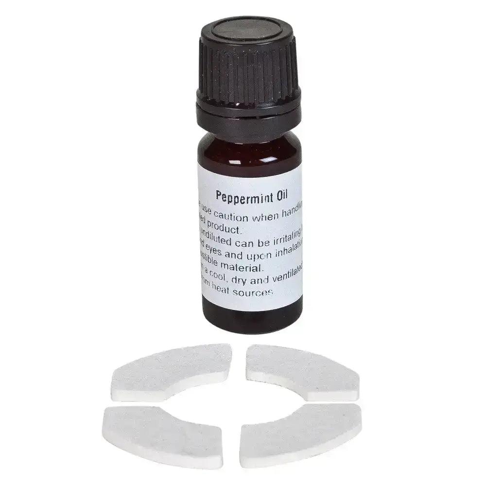 Dark amber glass bottle with black cap labeled peppermint oil next to white ceramic pieces in bizzy horse aromatherapy kit