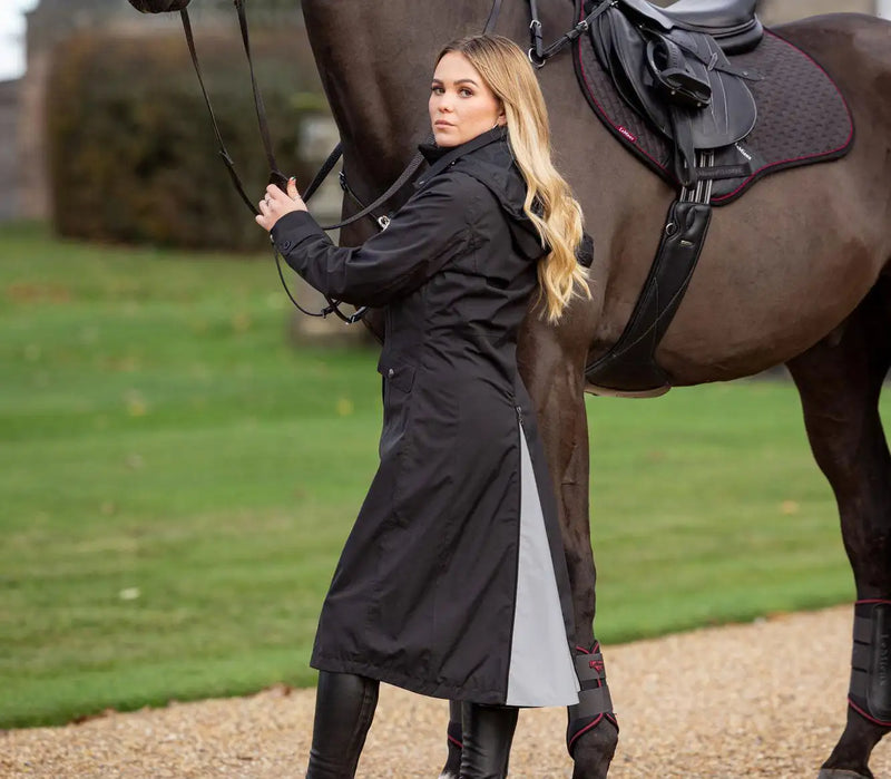 Black riding coat with a gray panel on the side and black leather accents