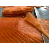 Fresh vibrant orange blakewell smokehouse superior cold smoked salmon fillet with visible muscle lines and glistening surface kiln smoked
