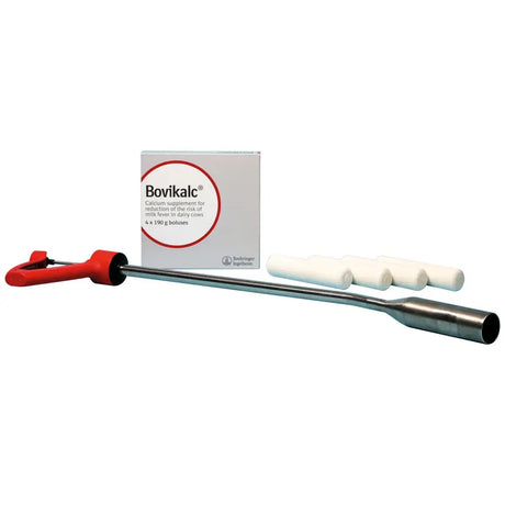 Red-handled metal bovikalc applicator with four white boluses next to boehringer ingelheim bovikalc box