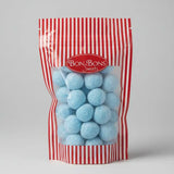 A red and white striped pouch of bon bon sweets pouches with light blue round candies coated in sugar coatings