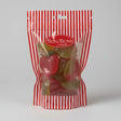 A red and white striped plastic bag of bon bon sweets pouches filled with colorful apple shaped gummies with sugar coatings