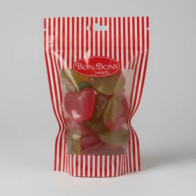 A red and white striped plastic bag of bon bon sweets pouches filled with colorful apple shaped gummies with sugar coatings
