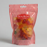 A red and white striped resealable bag of bon bon sweets pouches filled with colorful gummy bears and sugar coatings