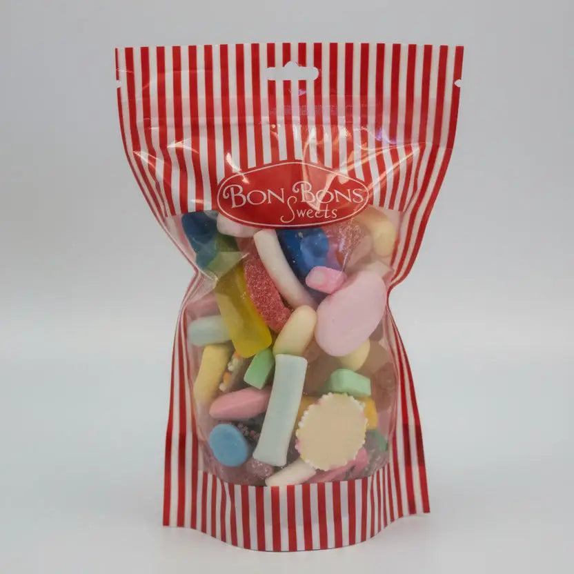A red and white striped plastic bag filled with colorful assorted hard candies with sugar coatings from bon bon sweets pouches