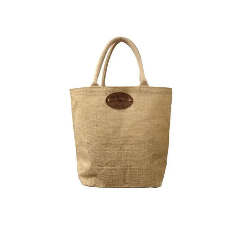 Beige borstiq jute tote bag with matching handles and brown leather patch perfect as a grooming kit tote