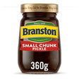 A glass jar of branstone pickle small chunk with a gold lid and colorful blue yellow green red label