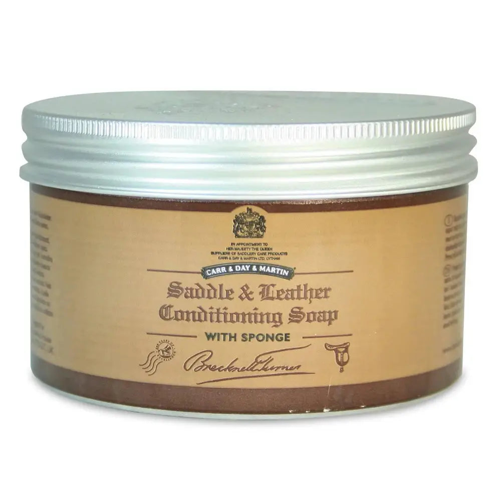 Brown jar of brecknell turner saddle soap with silver lid and attached sponge for traditional soft wax leather care