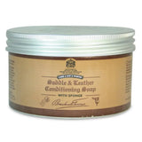 Brown jar of brecknell turner saddle soap with silver lid and attached sponge for traditional soft wax leather care