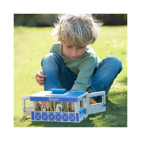 Blue and white wooden breyer farms wooden carry case stable toy with sliding doors showing miniature horses inside