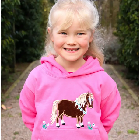 Smiling child in bright pink Flora Pony hoodie from British Country Collection