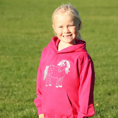 Smiling child in British Country Collection Twinkle Pony Glitter Hoodie with unicorn design