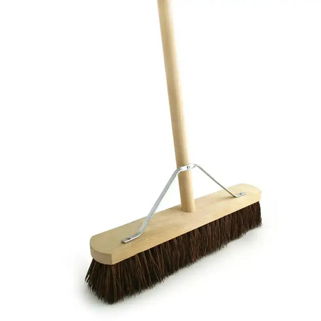 A sturdy bassine broom head fitted with dark brown bristles and a wooden 4’6 handle for easy sweeping