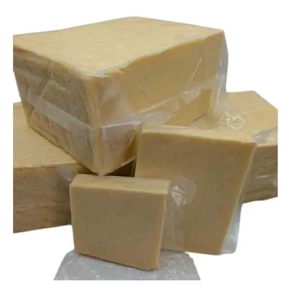 Stacks of pale yellow broomley cheddar selected mature cheddar wrapped in plastic from local dairy farms