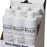 White plastic bottles of bucas rug wash for wool and all-in-one blankets designed for effective rug wash use
