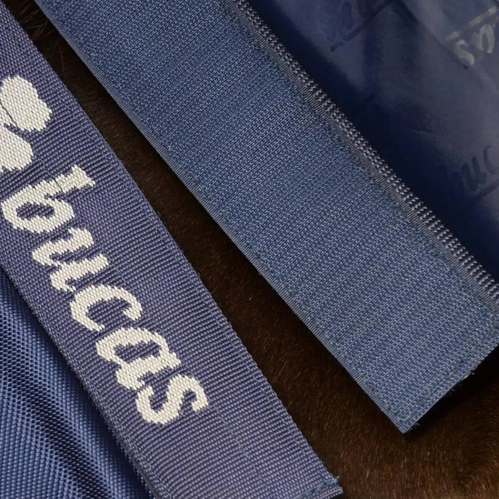 Dark blue woven ribbon with white princess text on bucas smartex rain sheet with stay-dry fleece lining