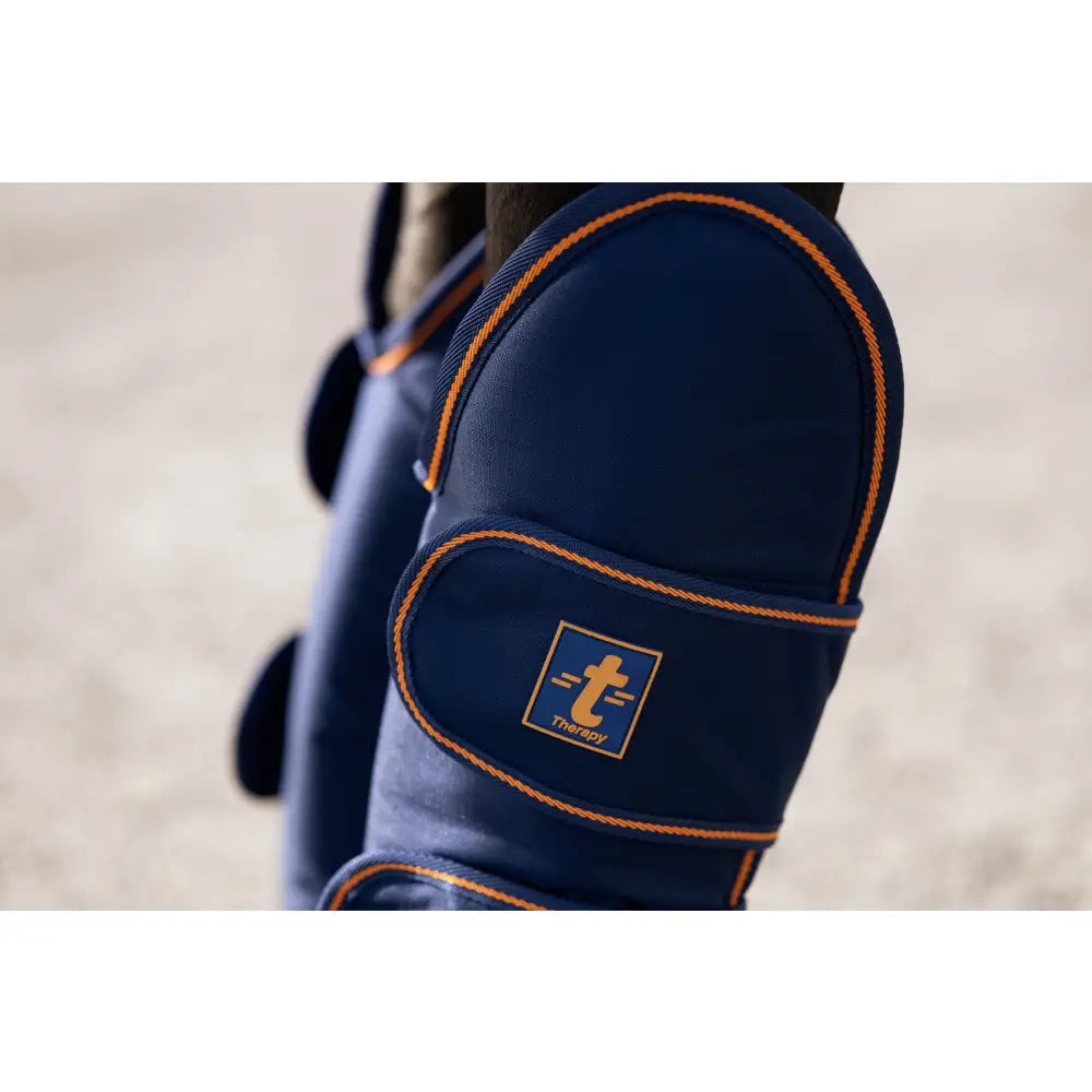 Navy blue bucas therapy travel boots with orange stitching ripstop outer and branded logo patch on horse leg wrap