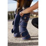 Navy blue bucas therapy travel boots with ripstop outer, orange stitching, padded horse leg wraps, small logo patch