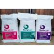 Three white bags of burlybale high fibre haylage horse feed with pink green and purple labels on north cornish coast