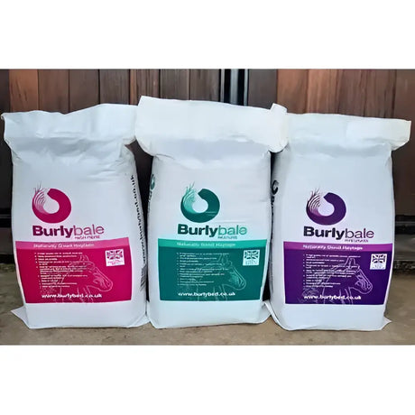 Three white bags of burlybale high fibre haylage horse feed with pink green and purple labels on north cornish coast