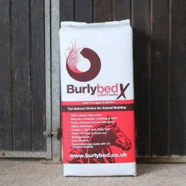 A white and red bag of burlybed lite extra straw horse bedding made from oilseed rape straw with a brown horse logo