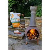 Terracotta burlyburn solid fuel metal chiminea with tall chimney and active fire burning using environmentally friendly heat logs
