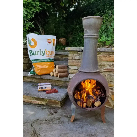 Terracotta burlyburn solid fuel metal chiminea with tall chimney and active fire burning using environmentally friendly heat logs