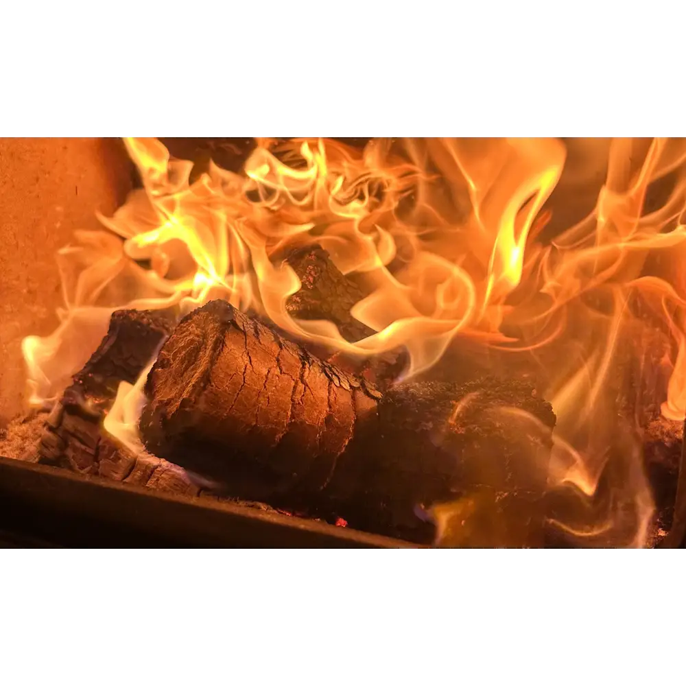 Burning Burlyburn Solid Fuel log in vibrant orange flames for efficient heating