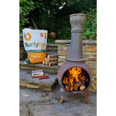 Rustic chiminea with burning Burlyburn Solid Fuel for cozy outdoor warmth