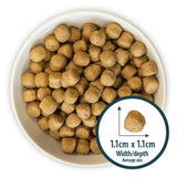 Brown round kibble pellets of burns original fish dog food by john burns in a white bowl