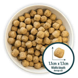 Brown round kibble pellets in a white bowl for burns sensitive pork dog food recommended by veterinary surgeon john