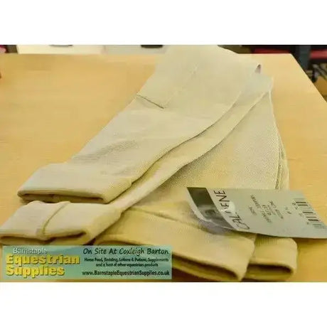 Beige cotton riding gloves with reinforced stitching and caldene tag matching caldene three tech childs jodhpurs with zig-zag cover stitch