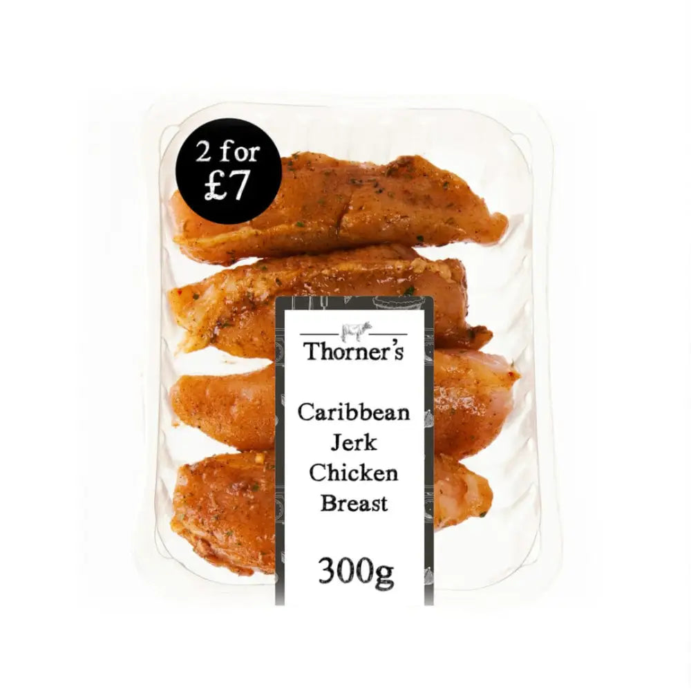 Thorners caribbean jerk chicken breasts marinated with visible spices in a clear tray of high-quality meat