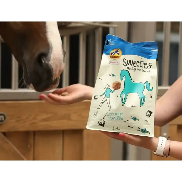 A blue and white bag of cavalor sweeties horse treats sweeties 750g with coconut vanilla flavor and maize germ meal