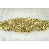 A pile of green and brown pelletized animal feed with yellow corn pieces from cavalor sportmash recup spec care