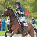 Brown horse with black mane and tail ridden by an equestrian wearing a dark blue charles owen 4star riding hat