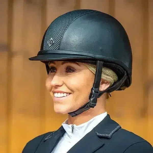Black charles owen ayr8 riding helmet with exclusive leather-look, textured mesh panel, and added elegance logo front