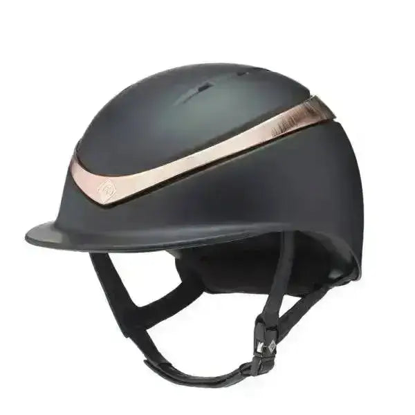 Black charles owen halo riding helmet with matte finish and rose gold accent stripe for equestrian use