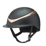 Black charles owen halo riding helmet with matte finish and rose gold accent stripe for equestrian use