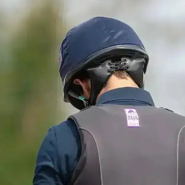 Dark blue charles owen pro 11 plus riding hat with black leather chin strap and adjustable buckle for precision-fitting cross-country skull