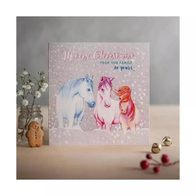 A soft pink christmas card on eco kraft fleck textured board with three horses and merry christmas text