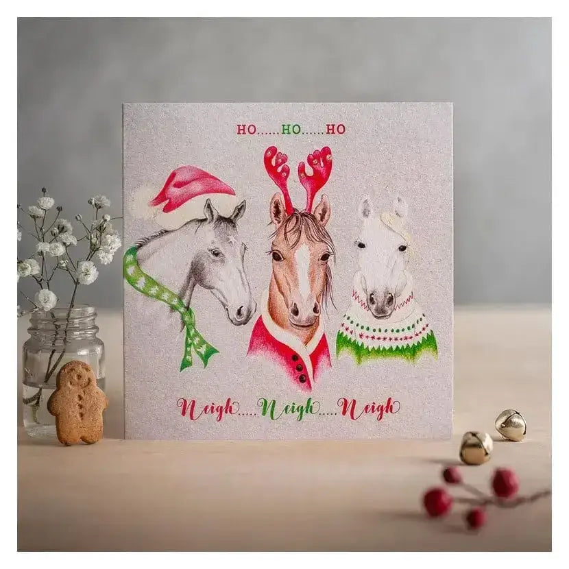 A festive christmas card ho ho ho with three horses in holiday attire printed on eco kraft fleck textured board