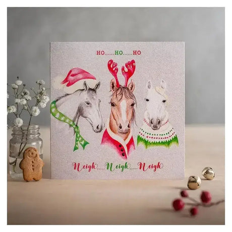 A festive christmas card ho ho ho with three horses in holiday attire printed on eco kraft fleck textured board