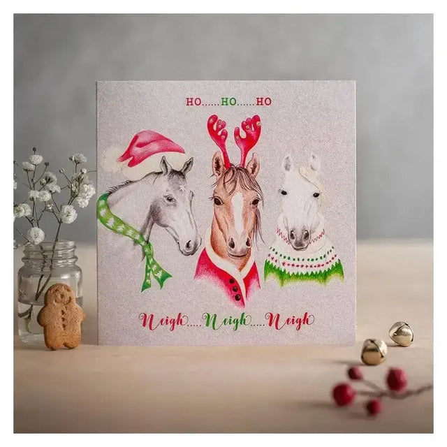 A festive christmas card ho ho ho with three horses in holiday attire printed on eco kraft fleck textured board