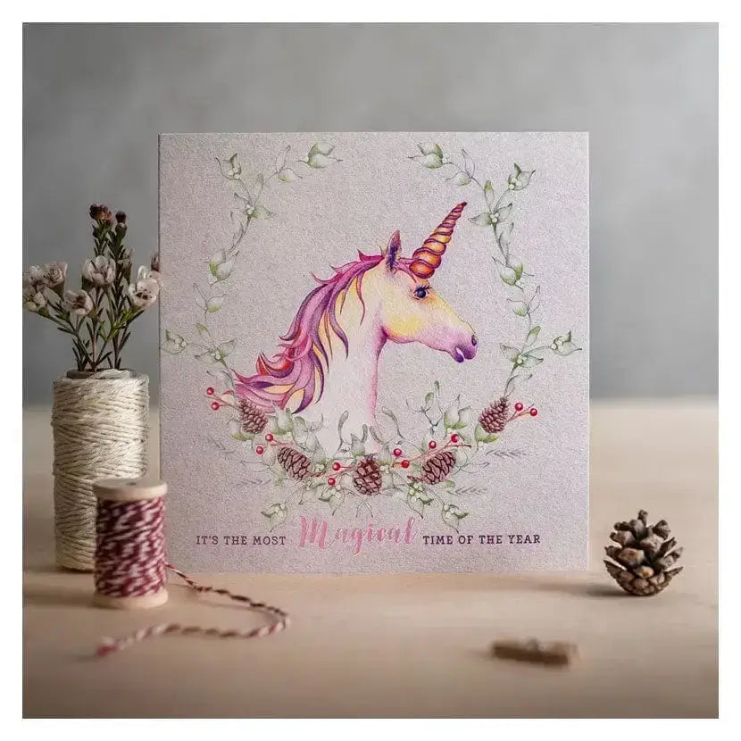 A delicate christmas card magical with a shimmering silver background and soft pink and gold accents in watercolor style