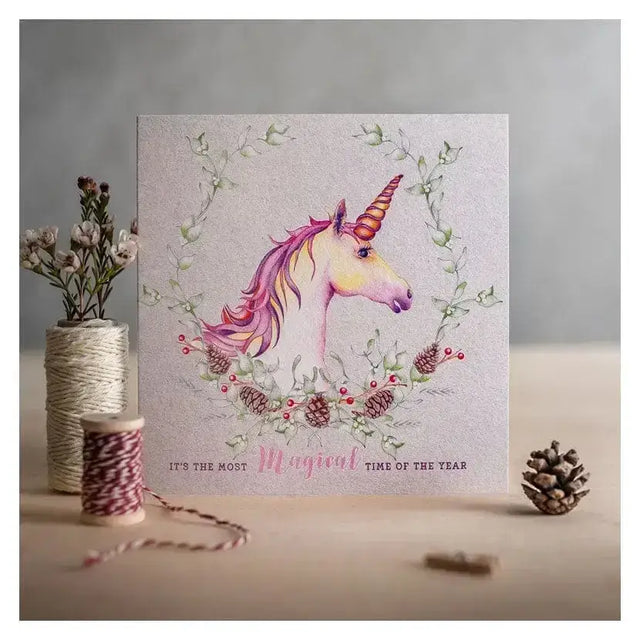 A delicate christmas card magical with a shimmering silver background and soft pink and gold accents in watercolor style