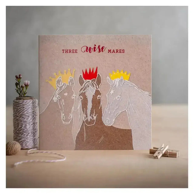 Beige eco kraft fleck christmas card three with minimalist white and brown illustration titled three wise mares in red script